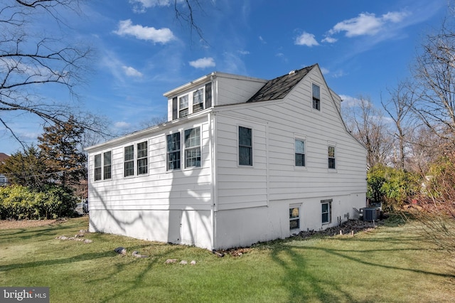 view of property exterior featuring cooling unit and a yard