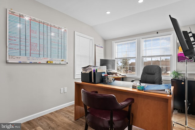 office space featuring lofted ceiling, baseboards, wood finished floors, and recessed lighting