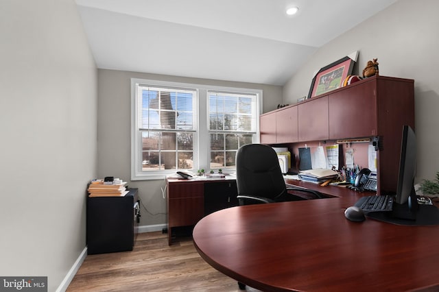 office area with lofted ceiling, light wood-style floors, and baseboards