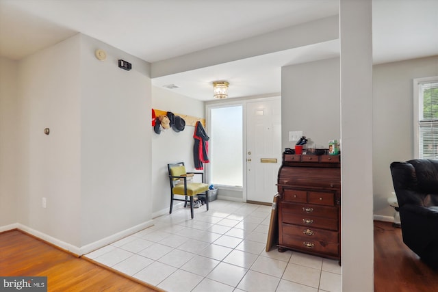 entrance foyer featuring light tile patterned floors and baseboards