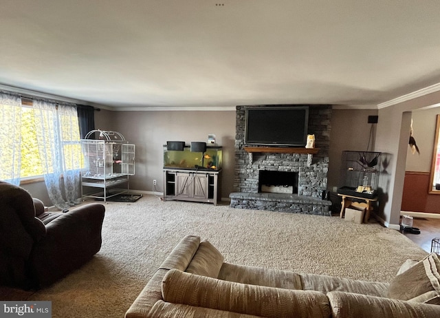 carpeted living room with baseboards, crown molding, and a stone fireplace