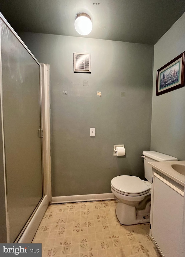 bathroom featuring a stall shower, baseboards, visible vents, toilet, and vanity