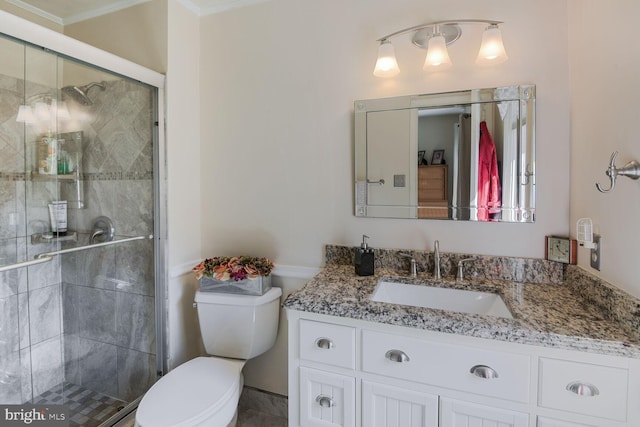 full bathroom featuring a stall shower, vanity, and toilet