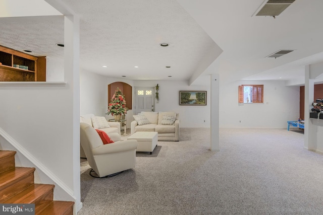 carpeted living room featuring a textured ceiling, stairway, a wealth of natural light, and recessed lighting