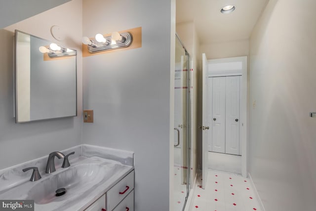 full bathroom with a shower stall, vanity, and tile patterned floors