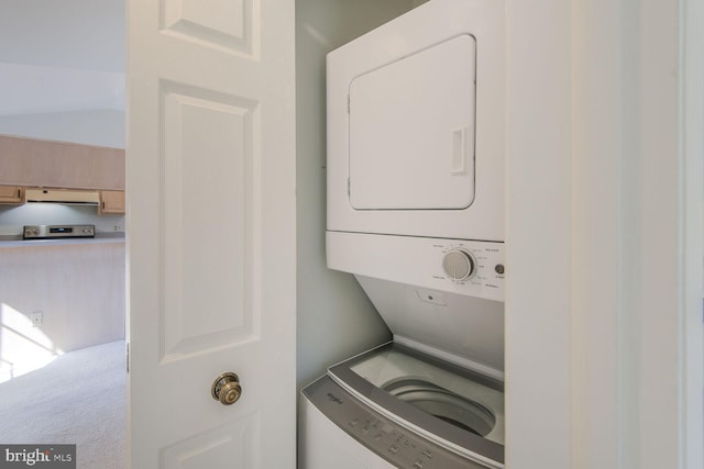 laundry area with stacked washing maching and dryer, carpet, and laundry area