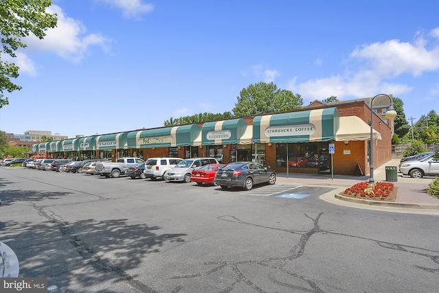 view of building exterior with uncovered parking