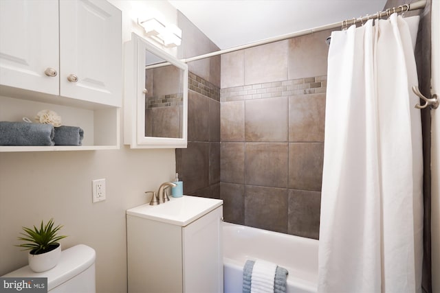 bathroom with shower / bath combo, vanity, and toilet