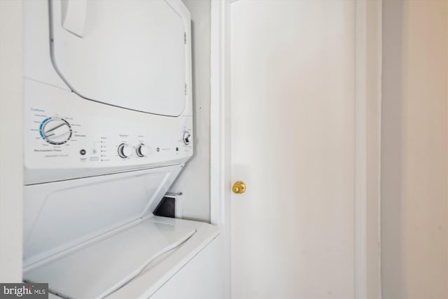 laundry area with stacked washer / dryer and laundry area