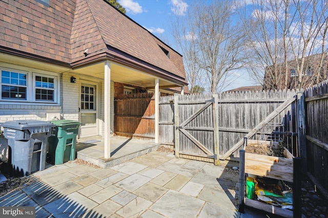 view of patio featuring a gate and fence