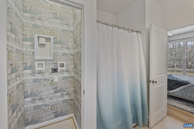 bathroom with wood walls