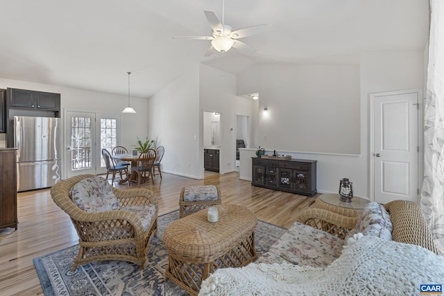 living room featuring light wood-style floors, ceiling fan, and high vaulted ceiling