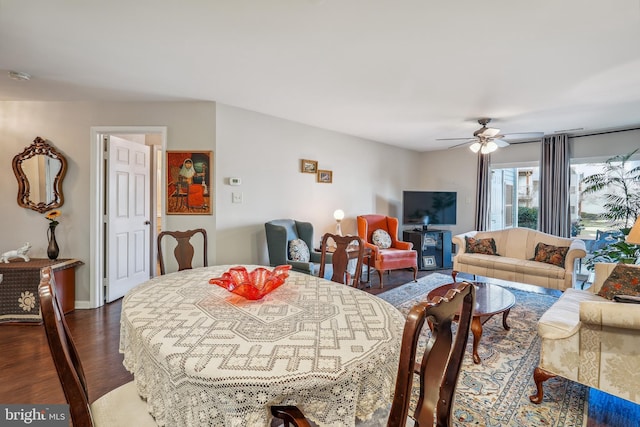 dining space with dark wood-type flooring and a ceiling fan