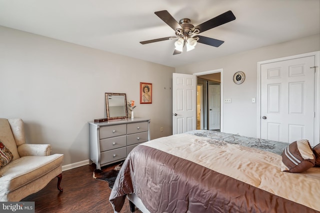 bedroom featuring ceiling fan, dark wood-style flooring, and baseboards