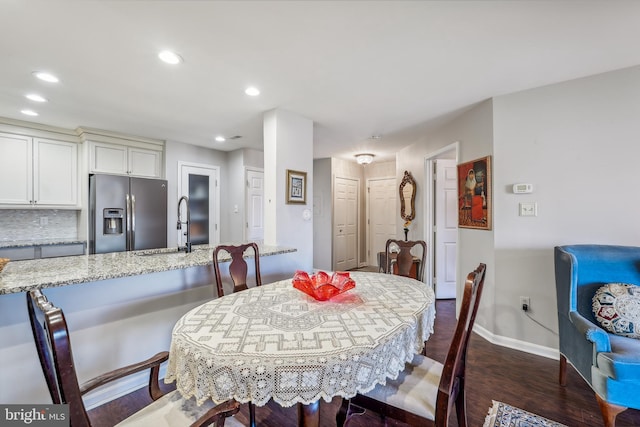 dining room featuring baseboards, dark wood-type flooring, and recessed lighting