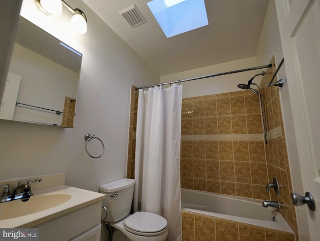 full bath featuring a skylight, visible vents, toilet, tiled shower / bath combo, and vanity