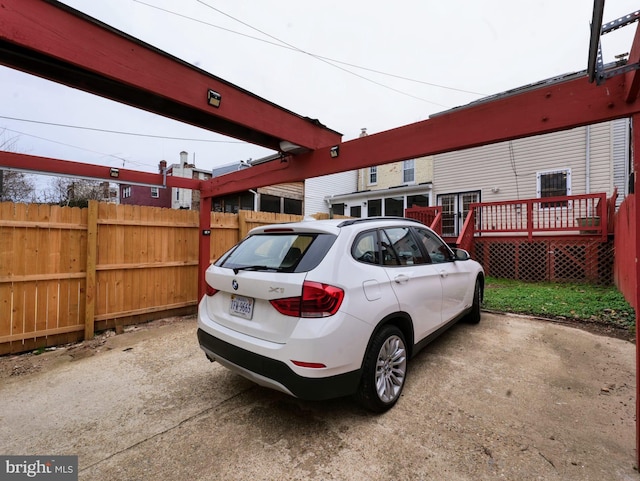 view of parking with fence