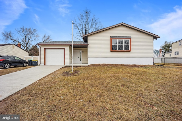 view of front of house with a garage, concrete driveway, a front yard, and fence