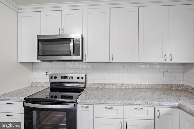 kitchen with appliances with stainless steel finishes and white cabinetry