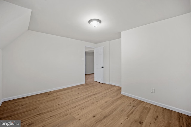 spare room featuring light wood-style flooring and baseboards