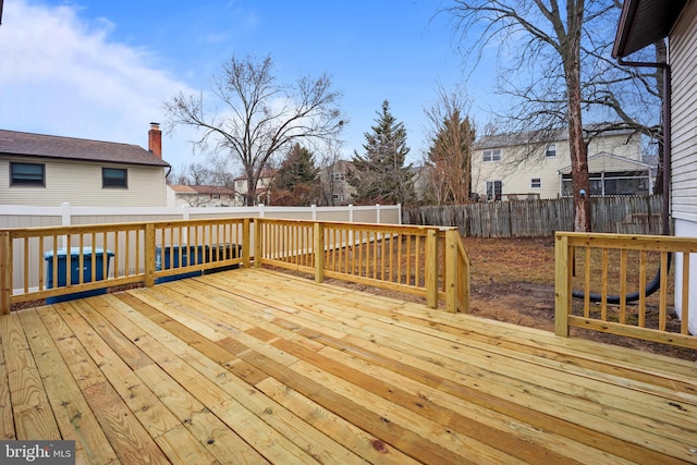 deck with a fenced backyard and a residential view