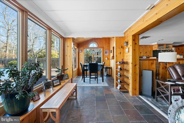 sunroom / solarium featuring vaulted ceiling