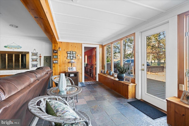 sunroom featuring beam ceiling