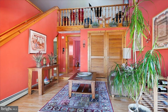 interior space with a baseboard heating unit and light wood-type flooring