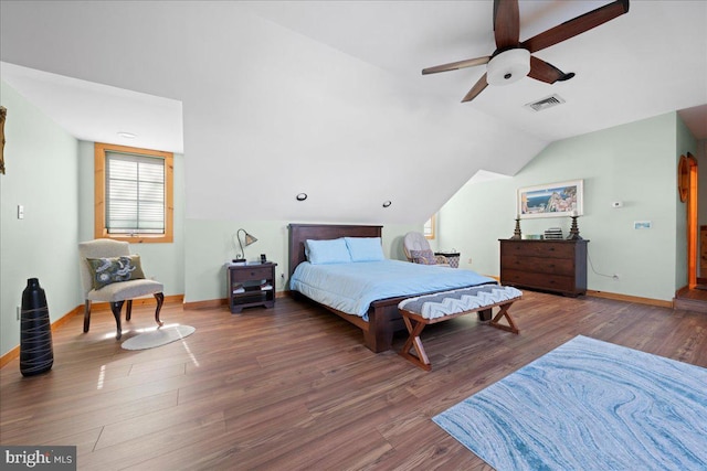 bedroom with dark wood-style floors, visible vents, a ceiling fan, vaulted ceiling, and baseboards