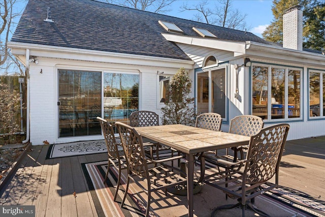 deck with outdoor dining area