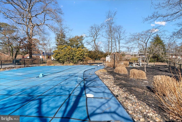 view of pool featuring fence