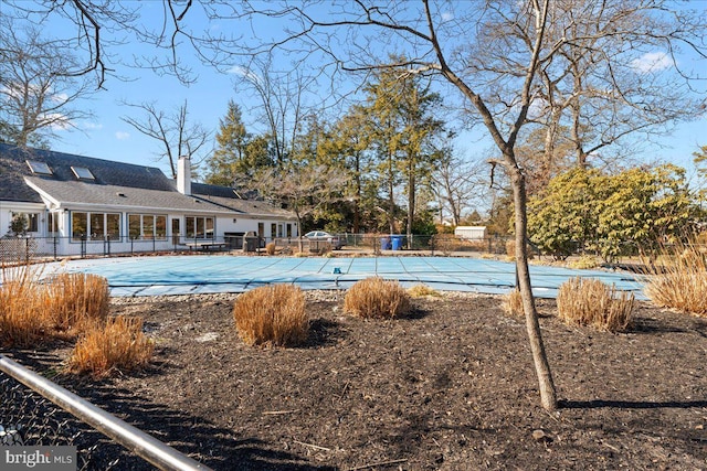 view of swimming pool featuring fence and a fenced in pool