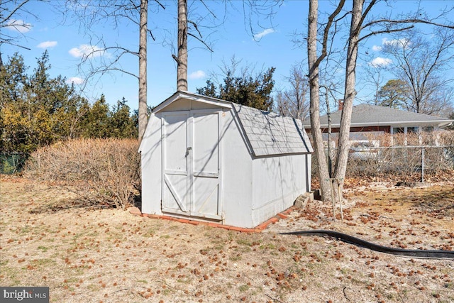 view of shed featuring fence