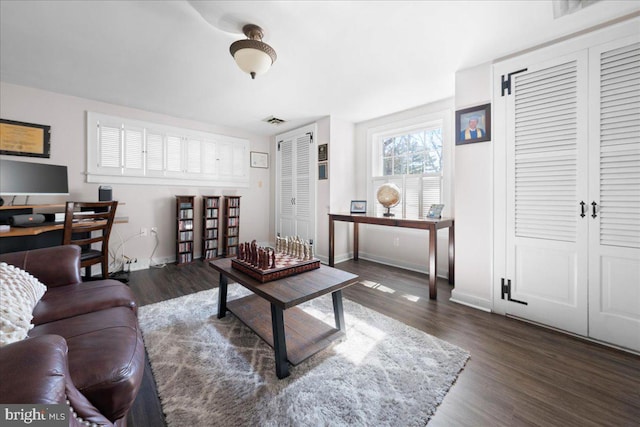 living room with visible vents, dark wood finished floors, and baseboards