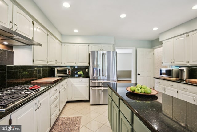 kitchen with white cabinetry, light tile patterned flooring, under cabinet range hood, decorative backsplash, and stainless steel appliances