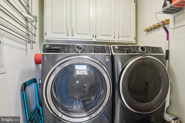 laundry area featuring cabinet space and washer and clothes dryer
