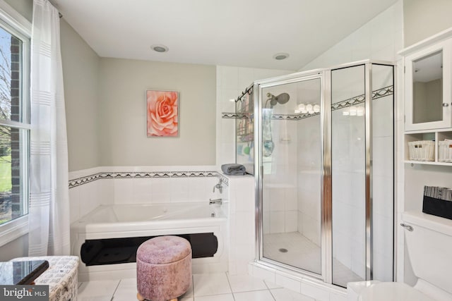 full bathroom featuring toilet, a shower stall, lofted ceiling, and a garden tub