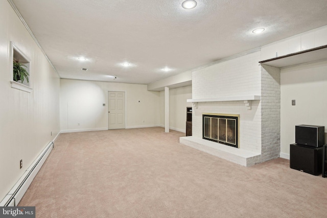 finished basement featuring light carpet, a fireplace, baseboard heating, and a textured ceiling