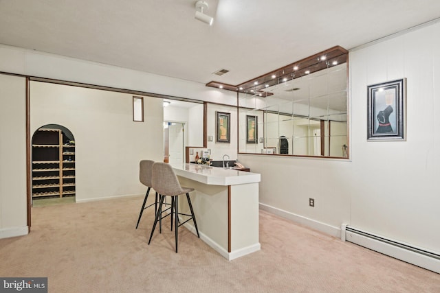 bar featuring visible vents, baseboards, light carpet, and baseboard heating