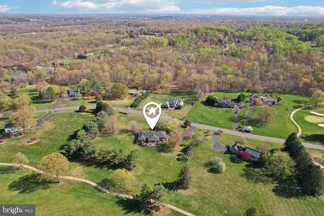 birds eye view of property with a forest view