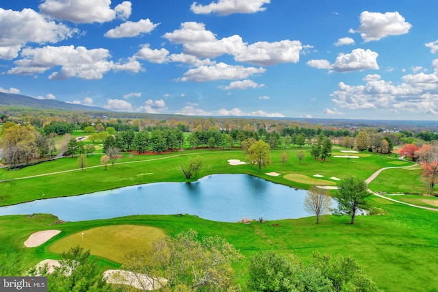 view of home's community featuring a water view, a lawn, and view of golf course