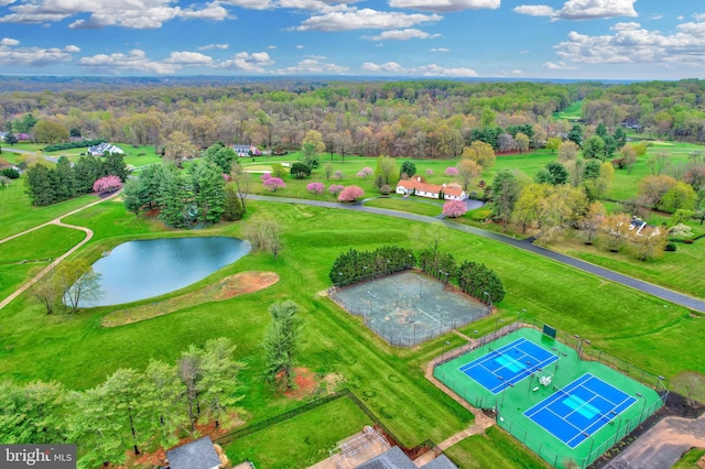 bird's eye view featuring a wooded view and a water view
