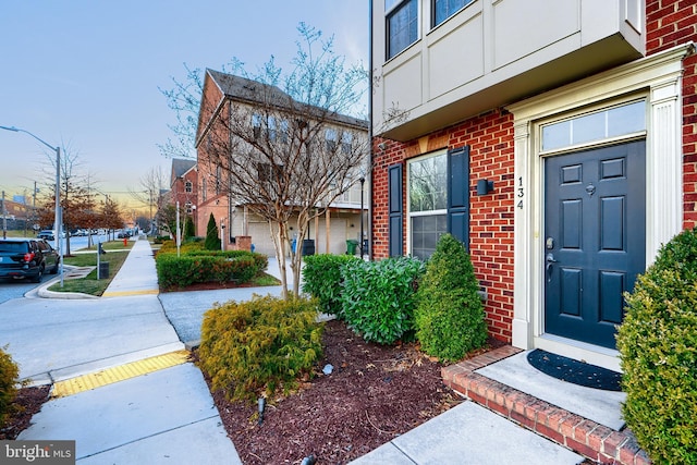 entrance to property with brick siding