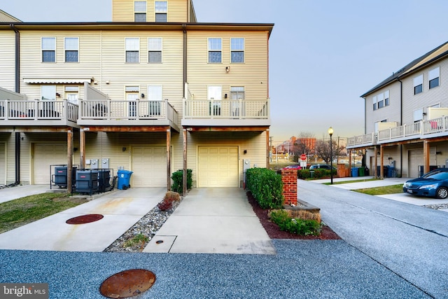 rear view of property with a garage and driveway