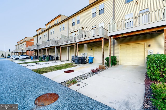 exterior space with a garage, driveway, and a residential view