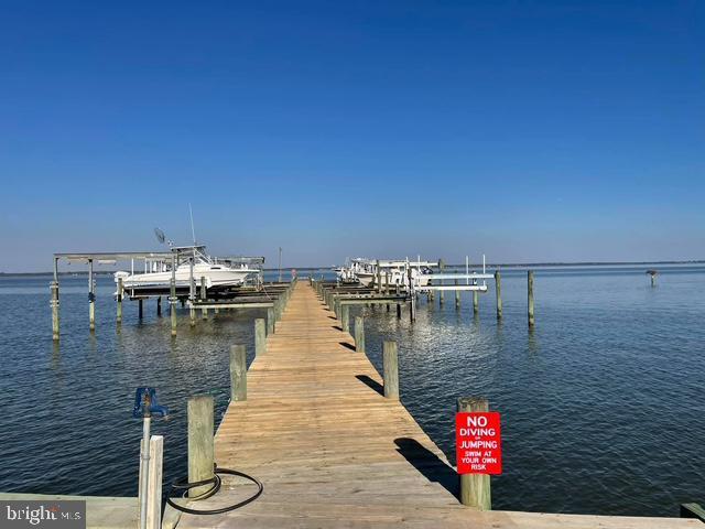 dock area with a water view and boat lift