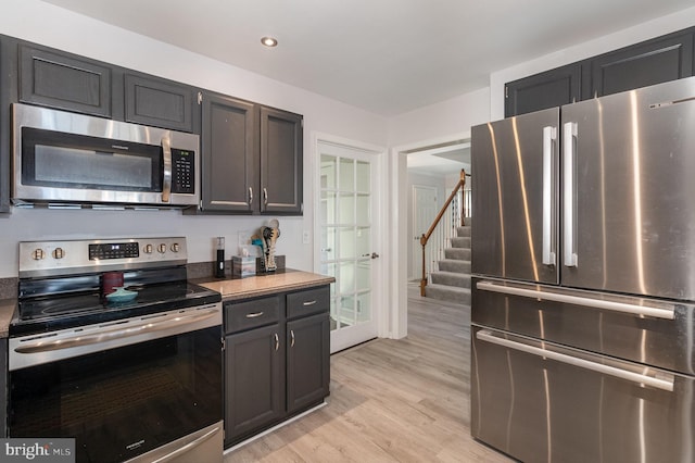 kitchen with recessed lighting, light wood-type flooring, and stainless steel appliances