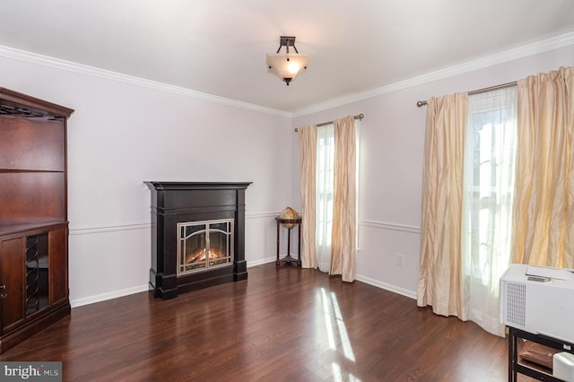 unfurnished living room with a glass covered fireplace, wood finished floors, and crown molding