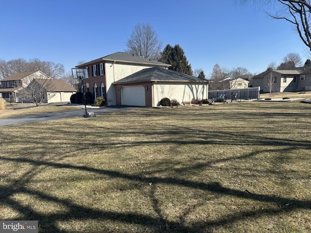 view of side of home with brick siding, fence, a residential view, a lawn, and driveway