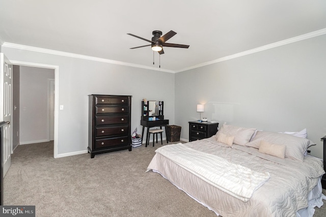 carpeted bedroom featuring ceiling fan, baseboards, and ornamental molding